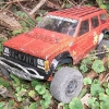 <strong class='magnific-title'>Traxxas Slash 4X4 (speckles the jeep)</strong> making the best of a bad situation. after carefully masking everything i sprayed the black, when i attempted to shoot the orange it sprayed like oatmeal so i did my best to get the whole shell evenly coated and just backed it in black.