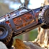 <strong class='magnific-title'>The Tiny Unit - Y.U.A.W.</strong> This is the Yeti Urban Assault Wagon, an urban assault wagon built off the Yeti chassis with Proline Racing's Apocalypse body and Super Swamper XL 2.2 Tires.
    Paint scheme is a marble/textured effect in Pearl Orange and Black with a White backer coat. Effect was achieved using Plastic Wrap to disrupt the paint after the Black coat was applied and still wet.